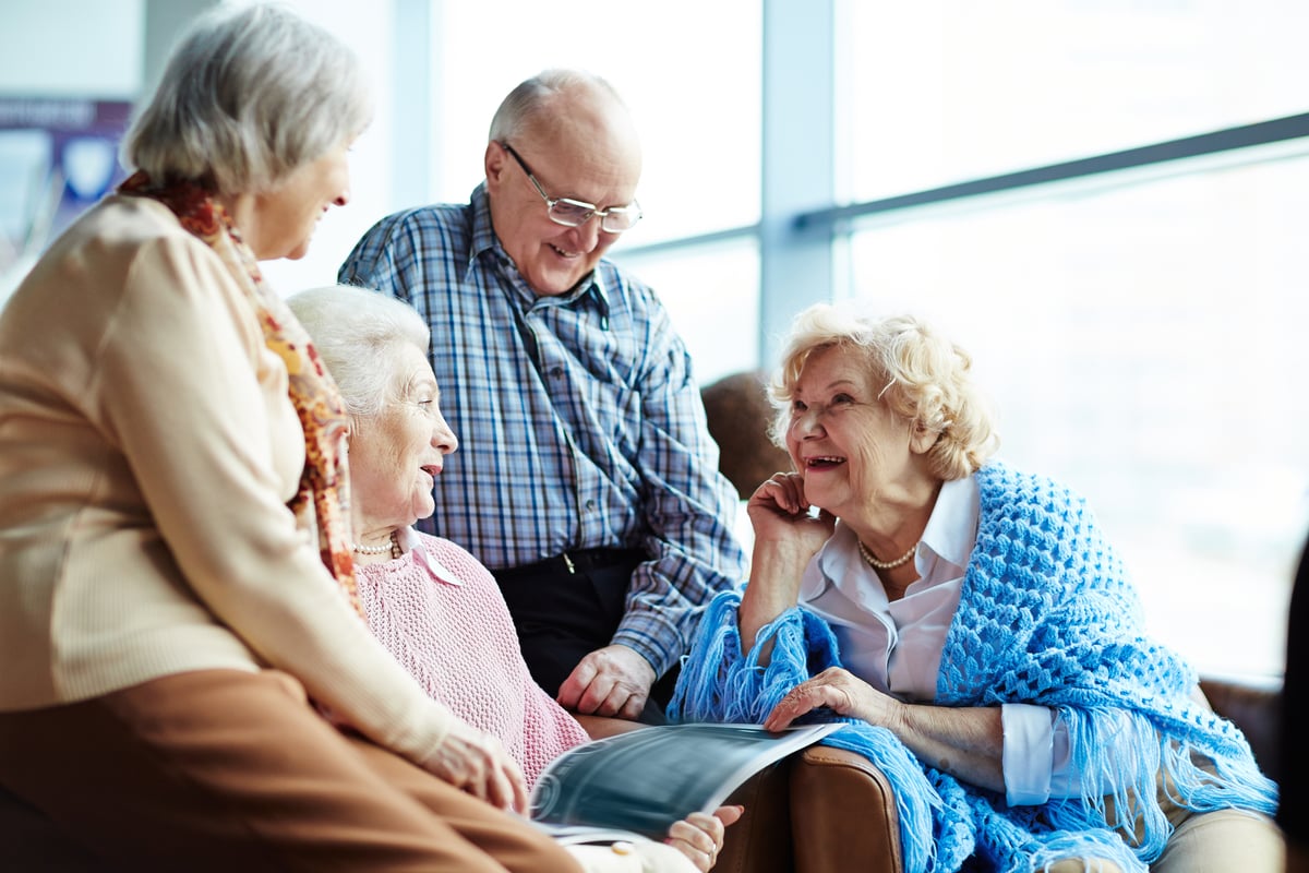 group of four seniors chatting