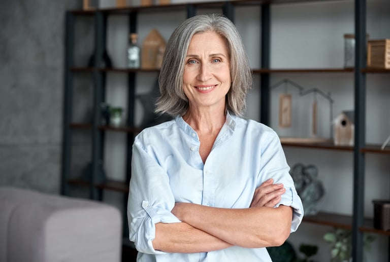 Happy older woman with arms crossed