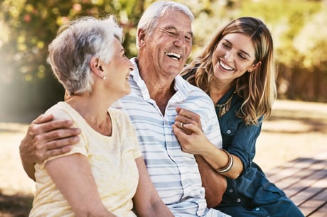 group of three people embracing outside