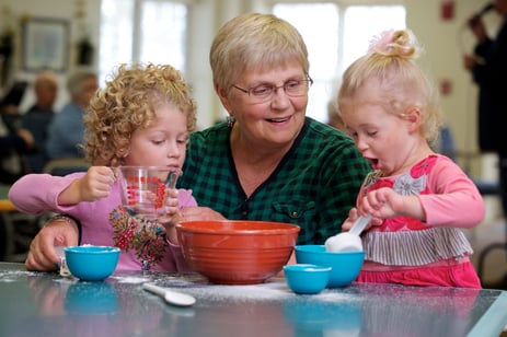 Woman cooking with her two granddaughters