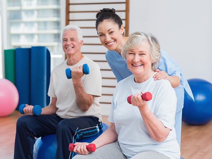 Portrait of happy instructor with senior couple