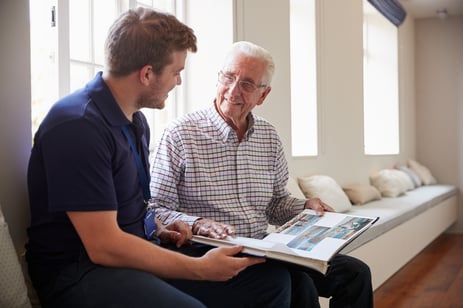 resident reading a book with his son