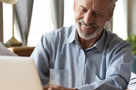 Man smiling over table