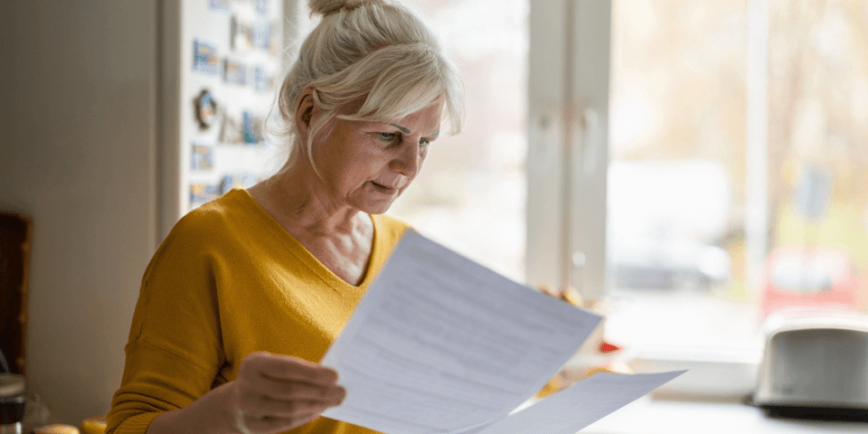 Senior woman filling out financial statements