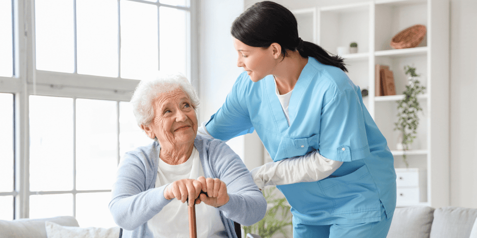 A nurse helping an older woman in her home