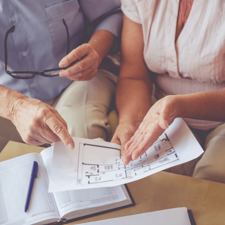 Woman and man looking at apartment floorplans