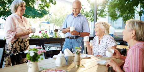 Group of people eating at a picnic table