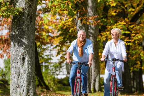 Woman and man riding their bicycles outside